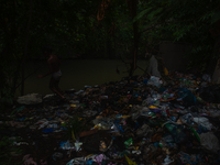 Children are playing in the polluted Babura River, which is contaminated with plastic waste, in Medan, North Sumatra, Indonesia, on February...