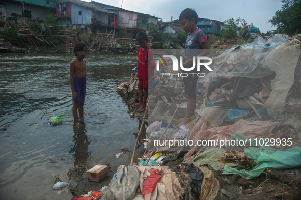 Boys are playing in the Deli River stream, which is polluted by plastic waste, in Medan, North Sumatra, Indonesia, on February 26, 2024. Eve...