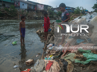 Boys are playing in the Deli River stream, which is polluted by plastic waste, in Medan, North Sumatra, Indonesia, on February 26, 2024. Eve...