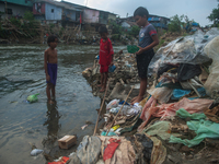 Boys are playing in the Deli River stream, which is polluted by plastic waste, in Medan, North Sumatra, Indonesia, on February 26, 2024. Eve...