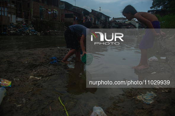 Boys are playing in the Deli River stream, which is polluted by plastic waste, in Medan, North Sumatra, Indonesia, on February 26, 2024. Eve...