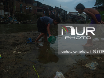 Boys are playing in the Deli River stream, which is polluted by plastic waste, in Medan, North Sumatra, Indonesia, on February 26, 2024. Eve...