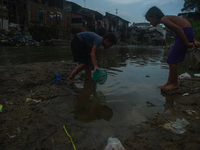 Boys are playing in the Deli River stream, which is polluted by plastic waste, in Medan, North Sumatra, Indonesia, on February 26, 2024. Eve...