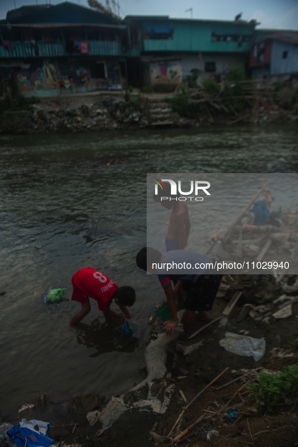 Boys are playing in the Deli River stream, which is polluted by plastic waste, in Medan, North Sumatra, Indonesia, on February 26, 2024. Eve...