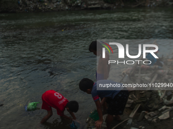 Boys are playing in the Deli River stream, which is polluted by plastic waste, in Medan, North Sumatra, Indonesia, on February 26, 2024. Eve...