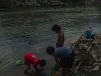 Boys are playing in the Deli River stream, which is polluted by plastic waste, in Medan, North Sumatra, Indonesia, on February 26, 2024. Eve...