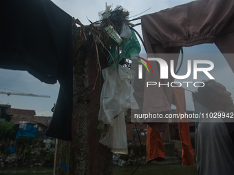 A resident is standing on the banks of the Deli River, which is polluted with plastic waste following floods, in Medan, North Sumatra, Indon...