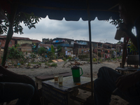 Residents are spending the afternoon on the banks of the polluted Deli River, which is contaminated with plastic waste after floods, in Meda...