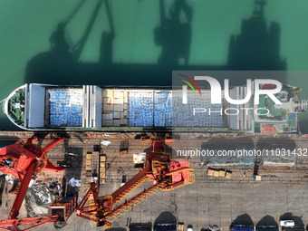 Cargo ships are unloading newly arrived chemical fertilizers at the port terminal in Lianyungang, East China's Jiangsu province, on February...