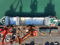 Cargo ships are unloading newly arrived chemical fertilizers at the port terminal in Lianyungang, East China's Jiangsu province, on February...