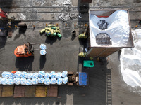 Dock workers are loading fertilizer that has been unloaded from a cargo ship at the port of Lianyungang, in Jiangsu Province, China, on Febr...