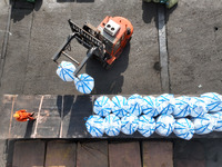 Dock workers are loading fertilizer that has been unloaded from a cargo ship at the port of Lianyungang, in Jiangsu Province, China, on Febr...