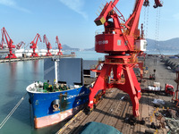 Cargo ships are unloading newly arrived chemical fertilizers at the port terminal in Lianyungang, East China's Jiangsu province, on February...