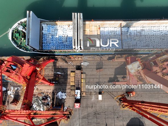 Cargo ships are unloading newly arrived chemical fertilizers at the port terminal in Lianyungang, East China's Jiangsu province, on February...