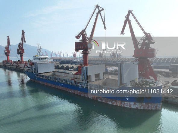 Cargo ships are unloading newly arrived chemical fertilizers at the port terminal in Lianyungang, East China's Jiangsu province, on February...