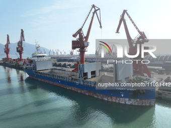 Cargo ships are unloading newly arrived chemical fertilizers at the port terminal in Lianyungang, East China's Jiangsu province, on February...