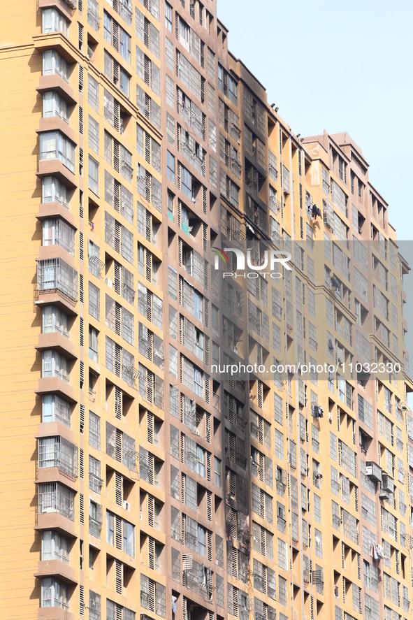 The facade of a high-rise building is blackened after a fire in the Mingshang Xiyuan residential area in the Yuhuatai district, in Nanjing,...