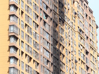 The facade of a high-rise building is blackened after a fire in the Mingshang Xiyuan residential area in the Yuhuatai district, in Nanjing,...