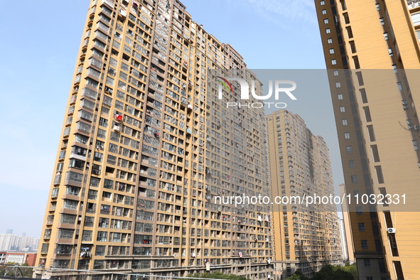 The facade of a high-rise building is blackened after a fire in the Mingshang Xiyuan residential area in the Yuhuatai district, in Nanjing,...