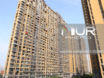 The facade of a high-rise building is blackened after a fire in the Mingshang Xiyuan residential area in the Yuhuatai district, in Nanjing,...