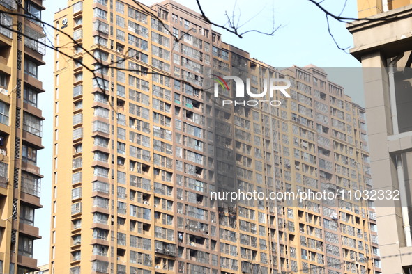 The facade of a high-rise building is blackened after a fire in the Mingshang Xiyuan residential area in the Yuhuatai district, in Nanjing,...