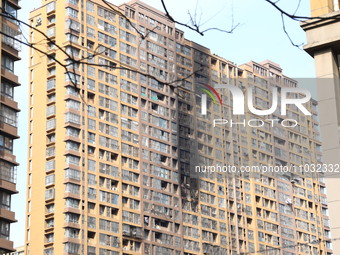 The facade of a high-rise building is blackened after a fire in the Mingshang Xiyuan residential area in the Yuhuatai district, in Nanjing,...