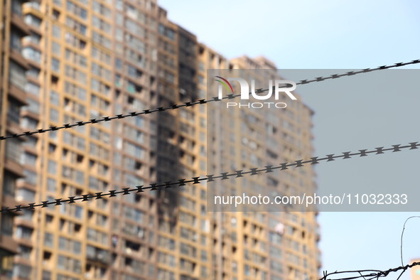 The facade of a high-rise building is blackened after a fire in the Mingshang Xiyuan residential area in the Yuhuatai district, in Nanjing,...