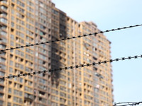 The facade of a high-rise building is blackened after a fire in the Mingshang Xiyuan residential area in the Yuhuatai district, in Nanjing,...