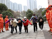 Firefighters are guiding residents to escape a fire in Lianyungang, China, on February 28, 2024. (