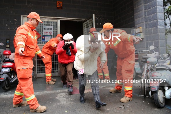 Residents are participating in an emergency escape drill for a high-rise building fire in Lianyungang, China, on February 28, 2024. 