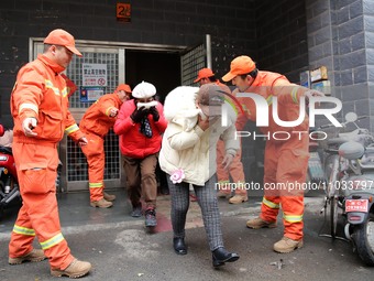 Residents are participating in an emergency escape drill for a high-rise building fire in Lianyungang, China, on February 28, 2024. (