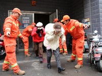 Residents are participating in an emergency escape drill for a high-rise building fire in Lianyungang, China, on February 28, 2024. (