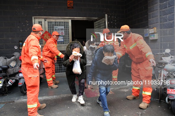 Residents are participating in an emergency escape drill for a high-rise building fire in Lianyungang, China, on February 28, 2024. 