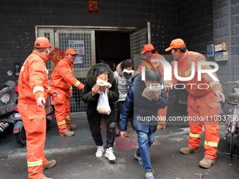 Residents are participating in an emergency escape drill for a high-rise building fire in Lianyungang, China, on February 28, 2024. (