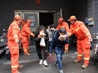 Residents are participating in an emergency escape drill for a high-rise building fire in Lianyungang, China, on February 28, 2024. (