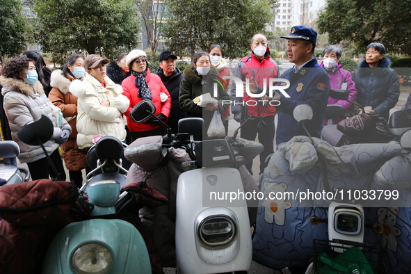 Firefighters are explaining the knowledge of safe storage and charging of electric vehicles to residents in Lianyungang, Jiangsu Province, C...