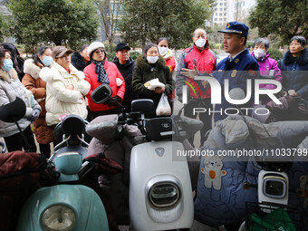 Firefighters are explaining the knowledge of safe storage and charging of electric vehicles to residents in Lianyungang, Jiangsu Province, C...