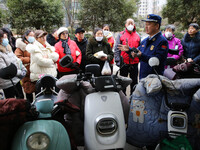 Firefighters are explaining the knowledge of safe storage and charging of electric vehicles to residents in Lianyungang, Jiangsu Province, C...