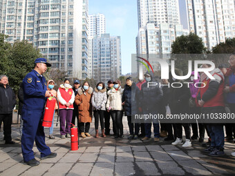 Firefighters are explaining the use of fire-fighting equipment to residents in Lianyungang, China, on February 28, 2024. (