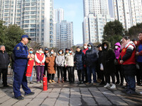 Firefighters are explaining the use of fire-fighting equipment to residents in Lianyungang, China, on February 28, 2024. (