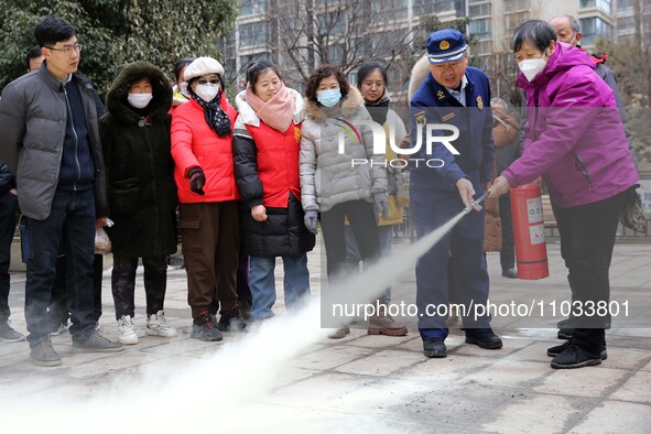 Firefighters are instructing residents on how to use fire-fighting equipment in Lianyungang, China, on February 28, 2024. 