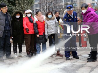 Firefighters are instructing residents on how to use fire-fighting equipment in Lianyungang, China, on February 28, 2024. (