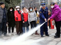 Firefighters are instructing residents on how to use fire-fighting equipment in Lianyungang, China, on February 28, 2024. (