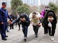 Firefighters are guiding residents to escape a fire in Lianyungang, China, on February 28, 2024. (