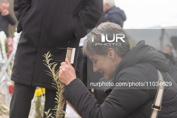 The mother of a young girl is crying in front of the sign that reads her deceased daughter's name, in Tempi Thessaly, Greece, on on February...