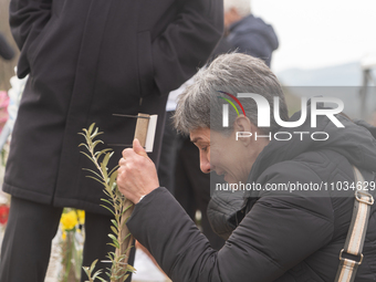 The mother of a young girl is crying in front of the sign that reads her deceased daughter's name, in Tempi Thessaly, Greece, on on February...