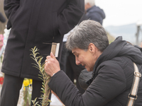 The mother of a young girl is crying in front of the sign that reads her deceased daughter's name, in Tempi Thessaly, Greece, on on February...