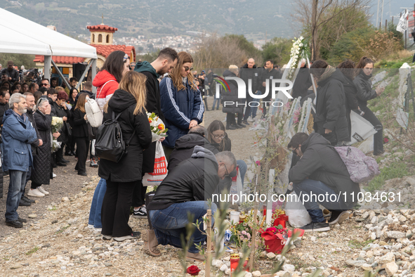 Relatives are laying flowers at the crash site during a one-year memorial service, in Tempi Thessaly, Greece, on on February 28, 2024. 