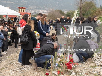 Relatives are laying flowers at the crash site during a one-year memorial service, in Tempi Thessaly, Greece, on on February 28, 2024. (