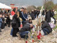 Relatives are laying flowers at the crash site during a one-year memorial service, in Tempi Thessaly, Greece, on on February 28, 2024. (